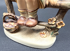 Close up of base of figurine.